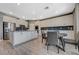 Bright open kitchen featuring an island with bar seating and modern stainless steel appliances at 10172 Fire Skye Ave, Las Vegas, NV 89166