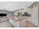 Open-concept kitchen with large island and modern appliances, connecting to the living area at 10172 Fire Skye Ave, Las Vegas, NV 89166