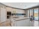 Stylish kitchen with an island, bar seating, stainless steel appliances, and outdoor access at 10172 Fire Skye Ave, Las Vegas, NV 89166