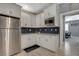 Modern kitchen featuring white cabinets, stainless steel appliances, and decorative backsplash at 10172 Fire Skye Ave, Las Vegas, NV 89166