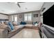 Expansive living room with a sectional sofa, wood-look tile flooring, and open layout, perfect for relaxation and entertaining at 10172 Fire Skye Ave, Las Vegas, NV 89166