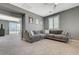 Large living room featuring neutral color scheme, plush gray sofa, bright light from windows, and a ceiling fan at 10172 Fire Skye Ave, Las Vegas, NV 89166