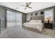 Luxurious main bedroom boasts a plush bed, ceiling fan, and sliding door to balcony at 10172 Fire Skye Ave, Las Vegas, NV 89166