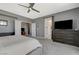 Well-lit main bedroom featuring neutral colors, soft carpet, and view to bathroom at 10172 Fire Skye Ave, Las Vegas, NV 89166