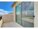 This covered patio includes a sliding glass door offering views of the community and blue skies at 10172 Fire Skye Ave, Las Vegas, NV 89166