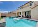 Relaxing backyard pool with a raised spa, covered patio, and lounge area at 10172 Fire Skye Ave, Las Vegas, NV 89166