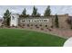 Stone signage at community entrance with green grass and plants at 10326 Scalata Ave, Las Vegas, NV 89166
