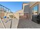 Backyard with patio pavers, grass area, swing set, and a covered outdoor sofa at 10468 Skye Knoll Ave, Las Vegas, NV 89166