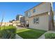 A grass backyard, swing set, covered patio, and block wall provide a tranquil outdoor experience at 10468 Skye Knoll Ave, Las Vegas, NV 89166