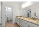 Bathroom showcasing a double sink vanity with granite countertops and tile flooring at 10468 Skye Knoll Ave, Las Vegas, NV 89166