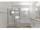 Bright bathroom featuring a tub, shower, and white vanity with granite countertop at 10468 Skye Knoll Ave, Las Vegas, NV 89166