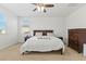 Bedroom boasting a bed, and dark wood furniture, all bathed in natural light at 10468 Skye Knoll Ave, Las Vegas, NV 89166