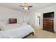 Bedroom featuring a bed with white comforter and dark wood furnishings at 10468 Skye Knoll Ave, Las Vegas, NV 89166