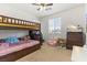 bedroom featuring a bunk bed, toy chest, area rug, and a window at 10468 Skye Knoll Ave, Las Vegas, NV 89166