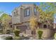 Charming two-story home featuring a stucco exterior, tile roof, manicured landscaping, and attached two-car garage at 10468 Skye Knoll Ave, Las Vegas, NV 89166