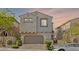 Charming home featuring a stucco exterior, a brick driveway, tile roofing, and an attached two-car garage at 10468 Skye Knoll Ave, Las Vegas, NV 89166