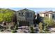 Exterior of the home featuring a large garage, paved driveway, and drought resistant landscaping at 10468 Skye Knoll Ave, Las Vegas, NV 89166
