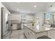 Open concept kitchen with stainless steel appliances, granite countertops, and a spacious island for dining at 10468 Skye Knoll Ave, Las Vegas, NV 89166