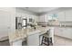 Stylish kitchen with white cabinets, stainless steel appliances, and an oversized island with barstool seating at 10468 Skye Knoll Ave, Las Vegas, NV 89166