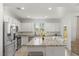 Bright kitchen featuring white cabinets, stainless steel appliances, and a large granite island with seating at 10468 Skye Knoll Ave, Las Vegas, NV 89166