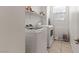 Laundry room with modern white washer and dryer, and tile floors at 10468 Skye Knoll Ave, Las Vegas, NV 89166