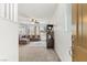 Open-concept living room with plush seating, neutral tones, and seamless flow to the kitchen at 10468 Skye Knoll Ave, Las Vegas, NV 89166