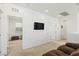 Loft featuring carpet flooring, neutral color scheme, a sofa and open door to bedroom at 10468 Skye Knoll Ave, Las Vegas, NV 89166