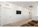 Cozy loft space featuring carpet flooring, neutral color scheme, and a wall-mounted television at 10468 Skye Knoll Ave, Las Vegas, NV 89166