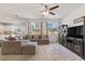 Bright living room featuring plush seating, large windows, ceiling fan, and modern décor creating a relaxing atmosphere at 10468 Skye Knoll Ave, Las Vegas, NV 89166