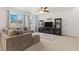 Comfortable living room featuring large windows, a plush sectional sofa, and stylish decor at 10468 Skye Knoll Ave, Las Vegas, NV 89166