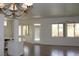 Spacious living room area featuring tile floors, modern lighting and backyard access at 10732 Cedar Creek Ave, Las Vegas, NV 89134