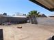 Spacious backyard featuring a block fence, some desert landscaping, and mature palm trees, perfect for outdoor entertaining at 1075 Greymouth St, Las Vegas, NV 89110