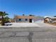 Charming single-story home featuring a low-maintenance rock garden and an attached two-car garage at 1075 Greymouth St, Las Vegas, NV 89110