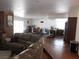 Inviting living room with wood-look flooring, brick accent wall, and abundant natural light at 1075 Greymouth St, Las Vegas, NV 89110