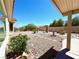 Backyard oasis featuring rock landscaping, desert plants, a fountain, and mature trees at 11025 Hawk Valley Ave, Las Vegas, NV 89134