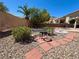 Landscaped backyard with rock, red paver sidewalk, patio furniture and view of the mountains in the distance at 11025 Hawk Valley Ave, Las Vegas, NV 89134