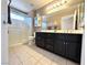 Bathroom featuring double vanity with black cabinets and a step-in shower at 11025 Hawk Valley Ave, Las Vegas, NV 89134