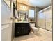 This bathroom features dark cabinets, a shower with glass doors, and a tiled floor at 11025 Hawk Valley Ave, Las Vegas, NV 89134