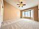 This is a spacious bedroom with neutral colors and bay windows providing lots of natural light at 11025 Hawk Valley Ave, Las Vegas, NV 89134
