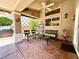 Relaxing covered patio with seating, a ceiling fan, and an outdoor kitchen at 11025 Hawk Valley Ave, Las Vegas, NV 89134