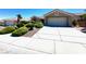 Inviting one-story home with a spacious driveway and tidy landscaping at 11025 Hawk Valley Ave, Las Vegas, NV 89134
