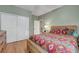 Relax in this cozy bedroom with a wood frame bed, a closet, and smooth wood floors at 112 Kava Kava St, Henderson, NV 89015