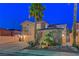 Inviting two-story home with a three-car garage, complimented by lush landscaping and a towering palm tree at 112 Kava Kava St, Henderson, NV 89015