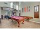Spacious game room with a pool table, shuffleboard table, bar, and ample room for entertainment at 112 Kava Kava St, Henderson, NV 89015