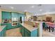 Well-lit kitchen featuring custom colored cabinetry, stainless steel appliances, and center island at 112 Kava Kava St, Henderson, NV 89015