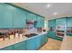 Beautiful kitchen with custom colored cabinets, stainless steel appliances and modern fixtures at 112 Kava Kava St, Henderson, NV 89015