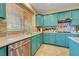 Kitchen with stainless steel appliances, custom colored cabinets, and tile backsplash at 112 Kava Kava St, Henderson, NV 89015