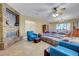 Comfortable living room with a stone fireplace, ceiling fan, and plush seating arrangement at 112 Kava Kava St, Henderson, NV 89015