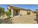 View of the backyard with a covered patio, barbecue area, and low-maintenance gravel landscaping at 11253 Sanbury Brook St, Las Vegas, NV 89183