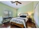 Bedroom features hardwood floors, a modern desk, and light green paint at 11253 Sanbury Brook St, Las Vegas, NV 89183